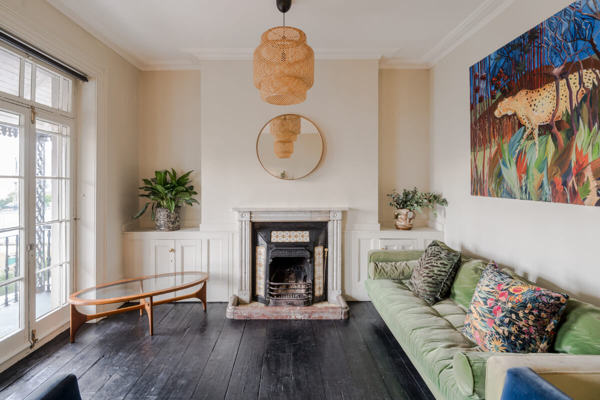 Timeworn Original Floorboards in a Regency Seaside Home 10 living room black wooden floor green sofa fireplace