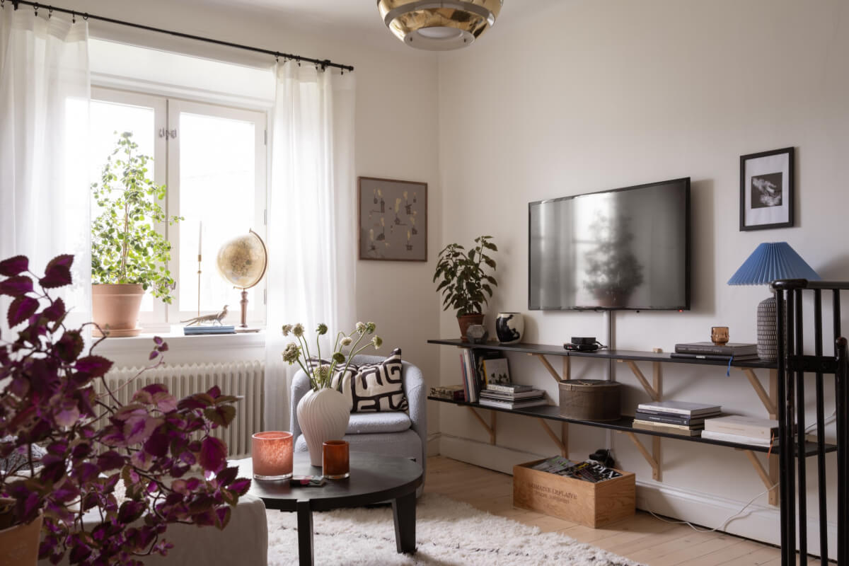 A Swedish Maisonette Apartment with Basement Bedrooms 3 living room black wooden shelves