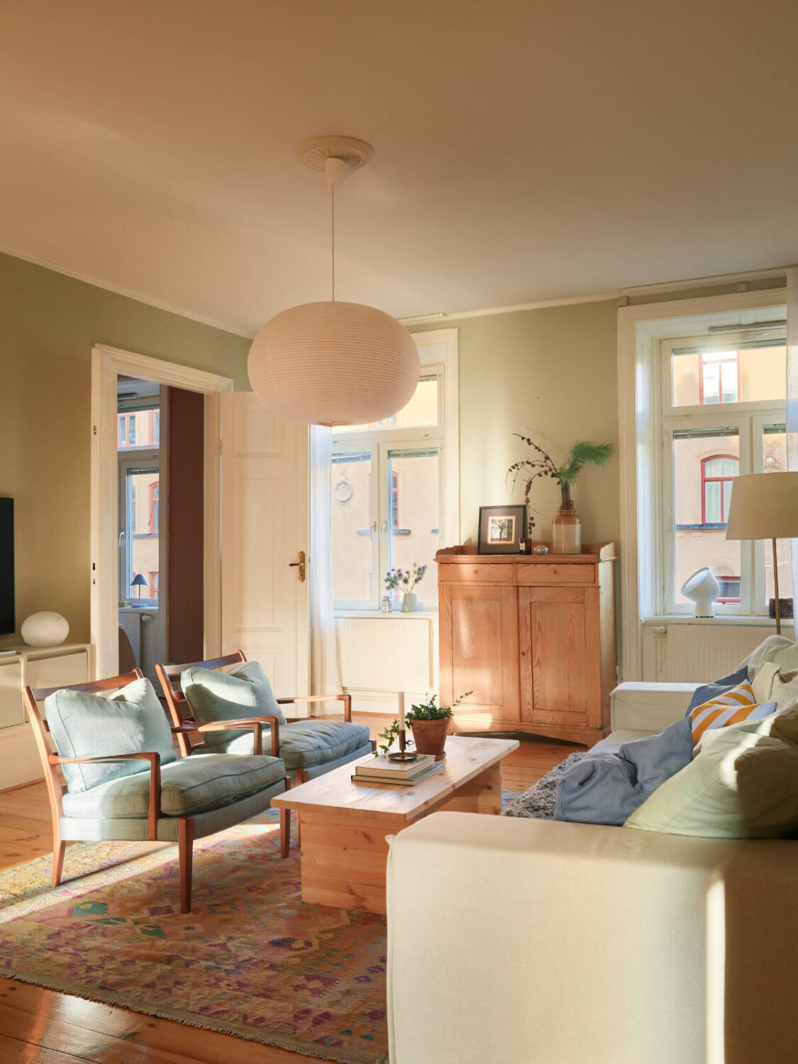 A Charming Historic Stockholm Apartment with a Blue Kitchen 18 living room blue armchairs