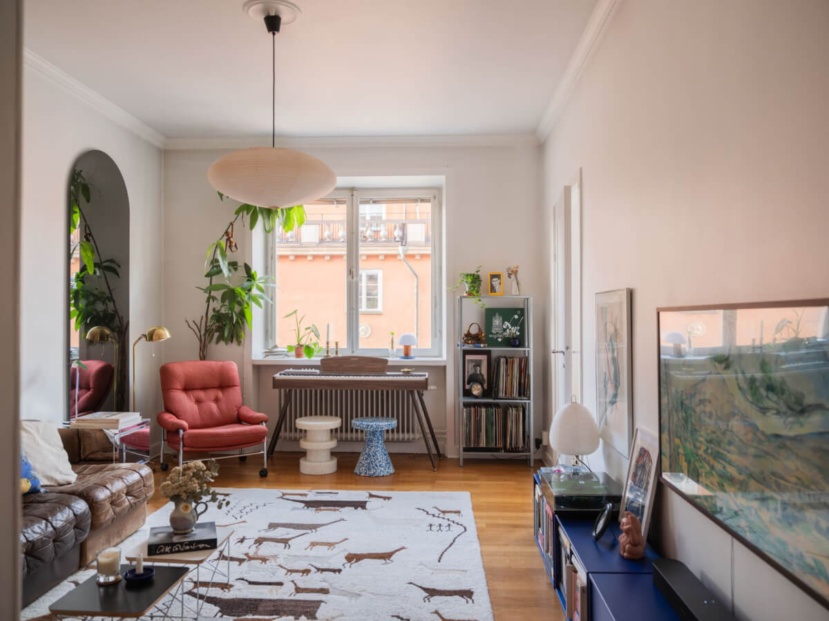 An Airy One-Bedroom Apartment with Art and A Yellow Kitchen 5 living room blue cabinets