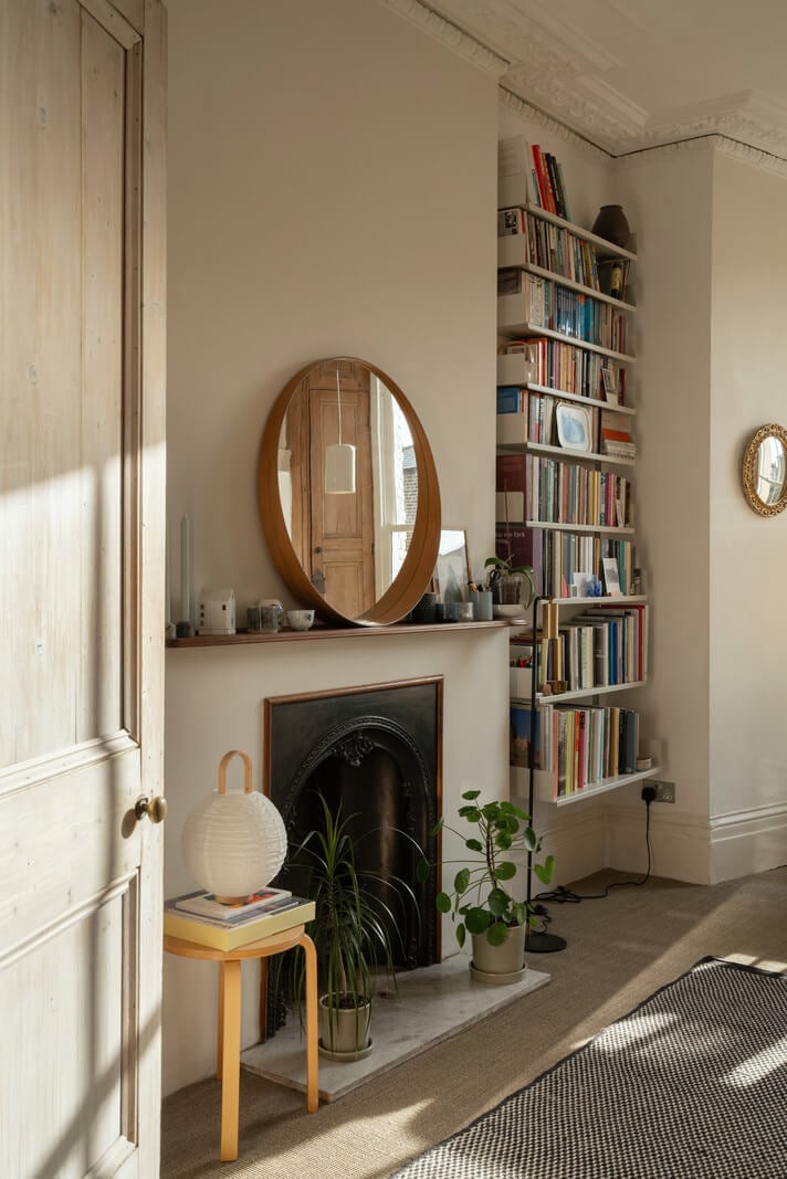 A Light One-Bedroom Apartment in a Victorian Terrace House 3 living room fireplace flanked by bookshelves
