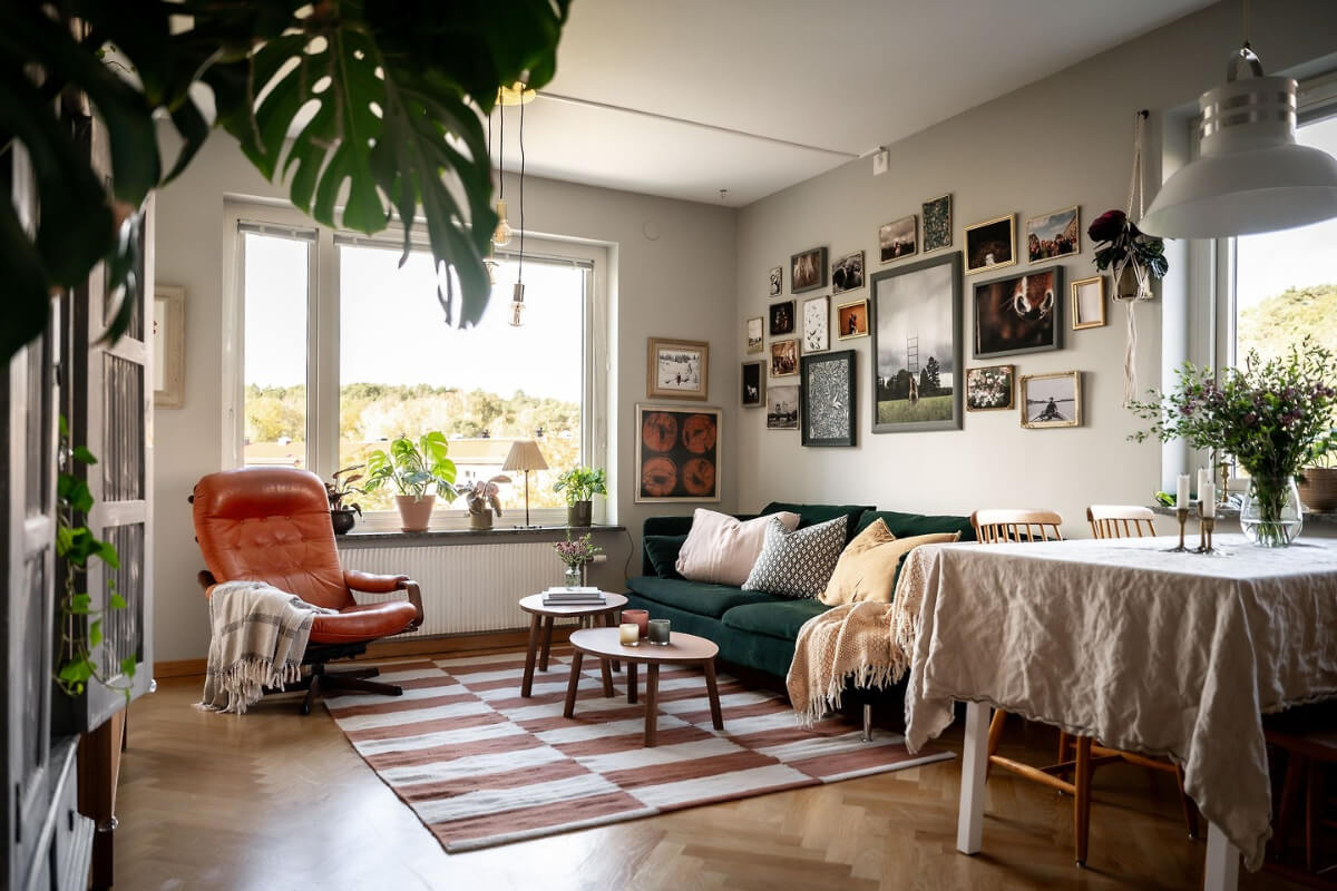 A Charming Apartment with Large Windows and Colorful Bedrooms 1 living room gallery wall striped rug
