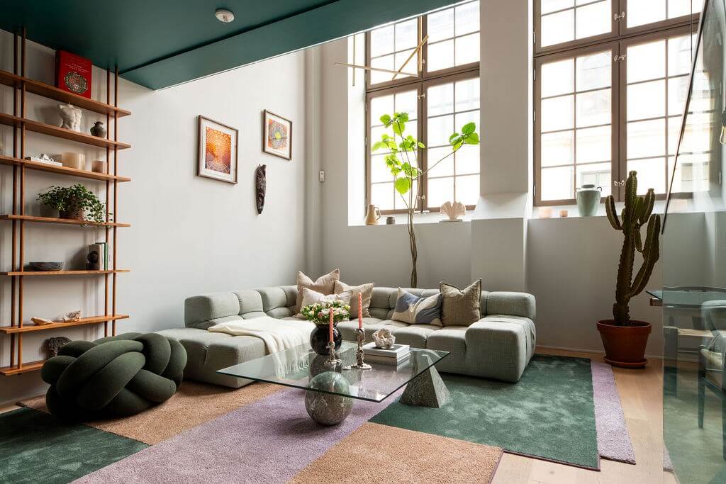 A Loft with High Ceilings and Large Windows in an Exclusive Stockholm Building 2 living room high windows colorful rug