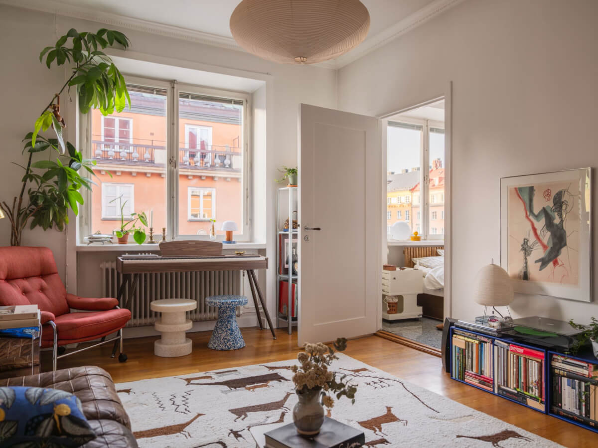 An Airy One-Bedroom Apartment with Art and A Yellow Kitchen 2 living room large animal rug