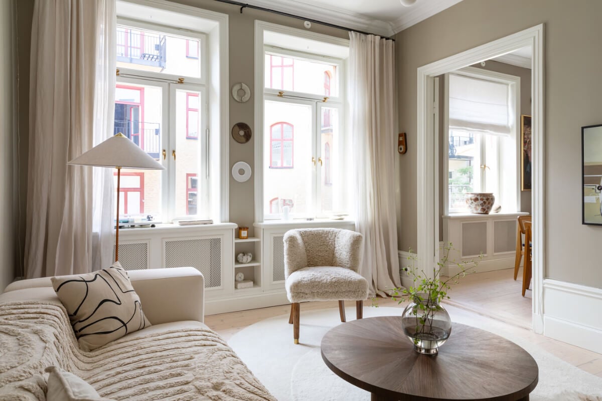 A Calm, Neutral Color Palette in a Classic Swedish Apartment 4 living room large windows sand colored walls nordroom