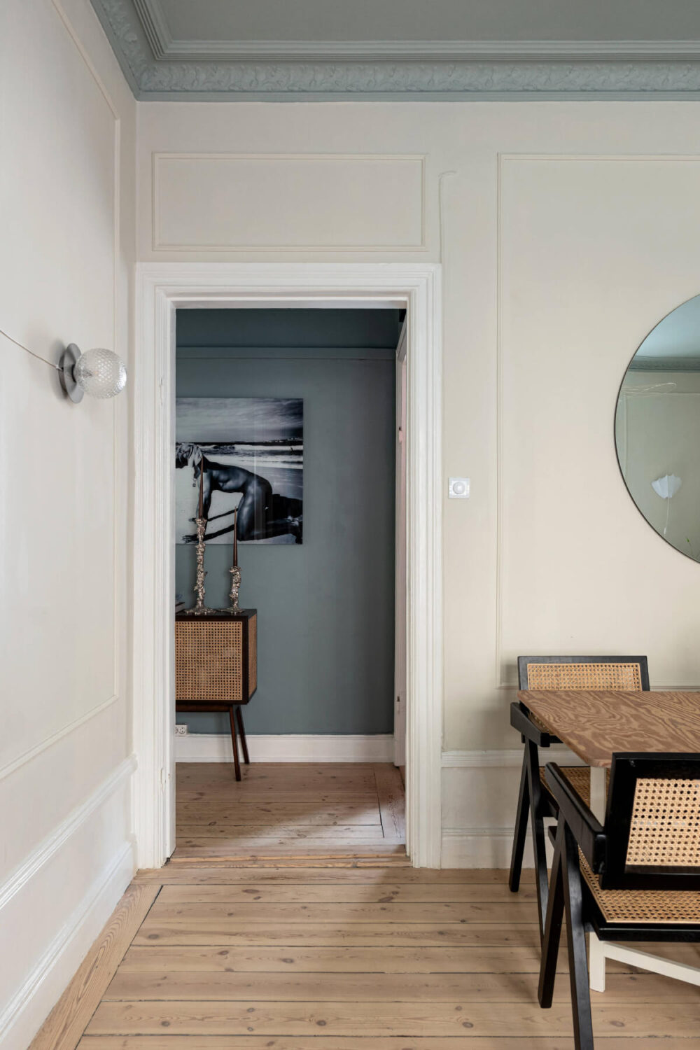 An Elegant Stockholm Apartment with a Pink and Black Kitchen 8 living room open doorway to hall