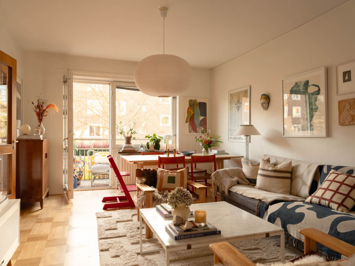 A Charming Midcentury Apartment with a Reading Room 1 living room parquet floor dining table and balcony