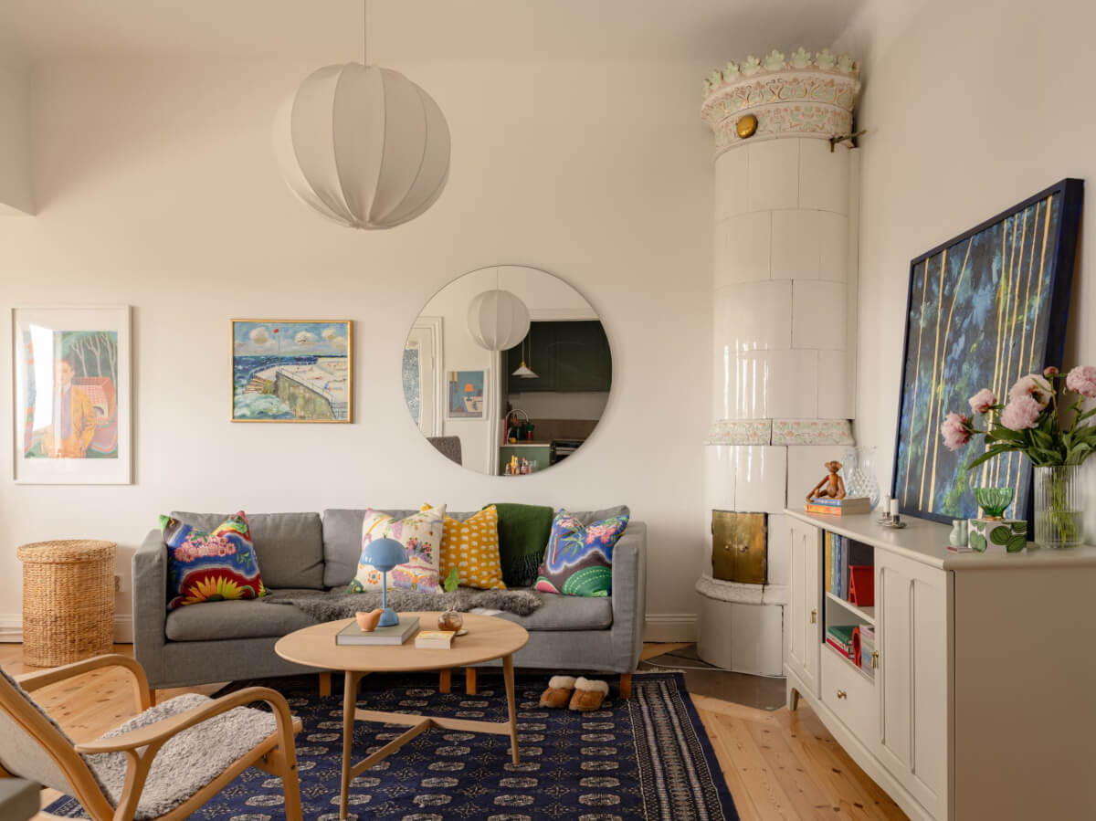 A Small Apartment with High Ceilings and a Large Bay Window 2 living room round mirror fireplace