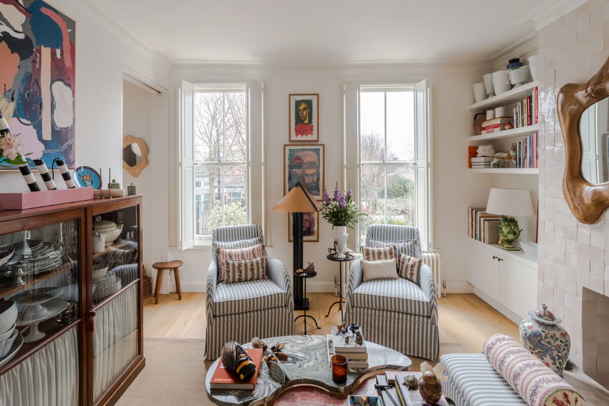 Cozy Contemporary Spaces in a Light-Filled Victorian Apartment 2 living room striped armchairs fireplace mantel pink zellige tiles