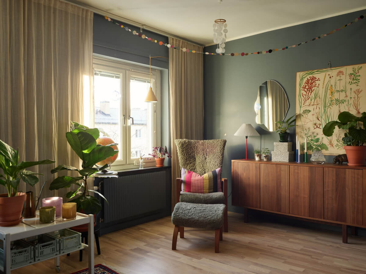 A Colorful Midcentury Apartment Filled with Art and Plants 7 living room walnut cabinet