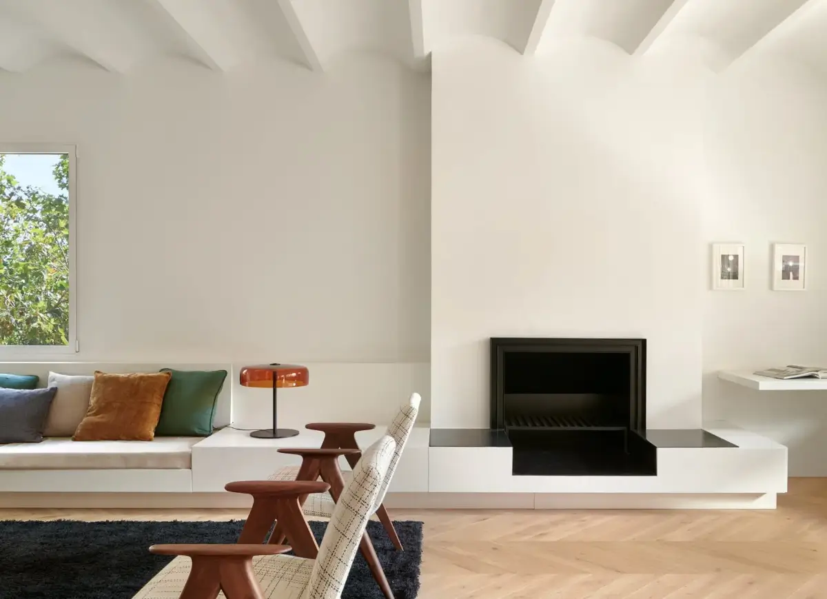 A Modern Barcelona Apartment with a Pink Bathroom 3 living room with built-in bench under window