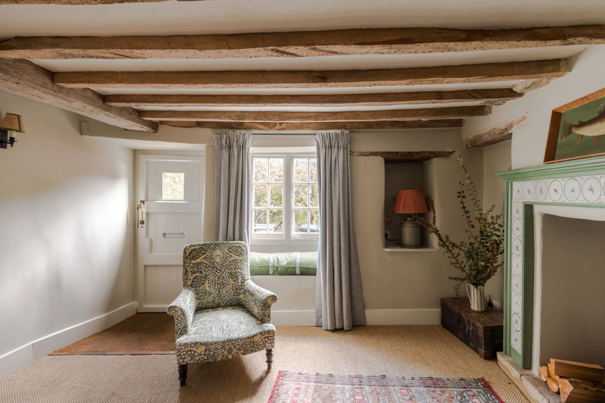 A Carefully Selected Color Palette in an 18th-Century English Cottage 2 living room with carpet window seat and wooden ceiling beams