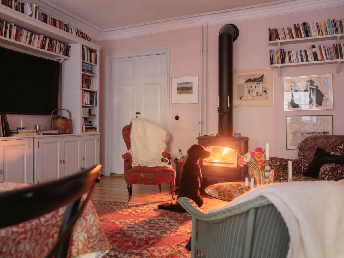 A Charming Home in a 17-Century Apartment in Stockholm's Old Town 7 living room with lighted wood burner