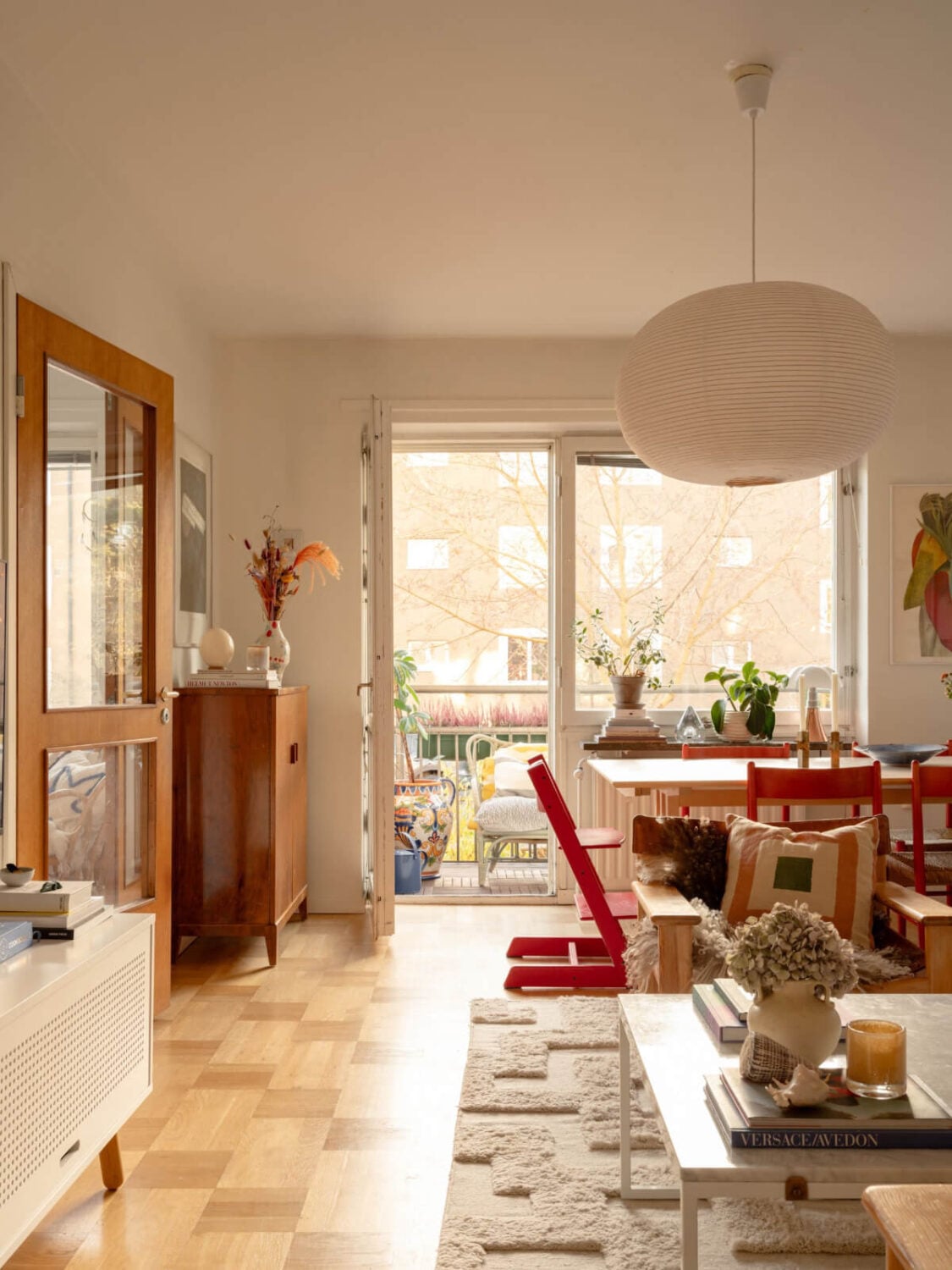 A Charming Midcentury Apartment with a Reading Room 7 living room with parquet floor and dining table
