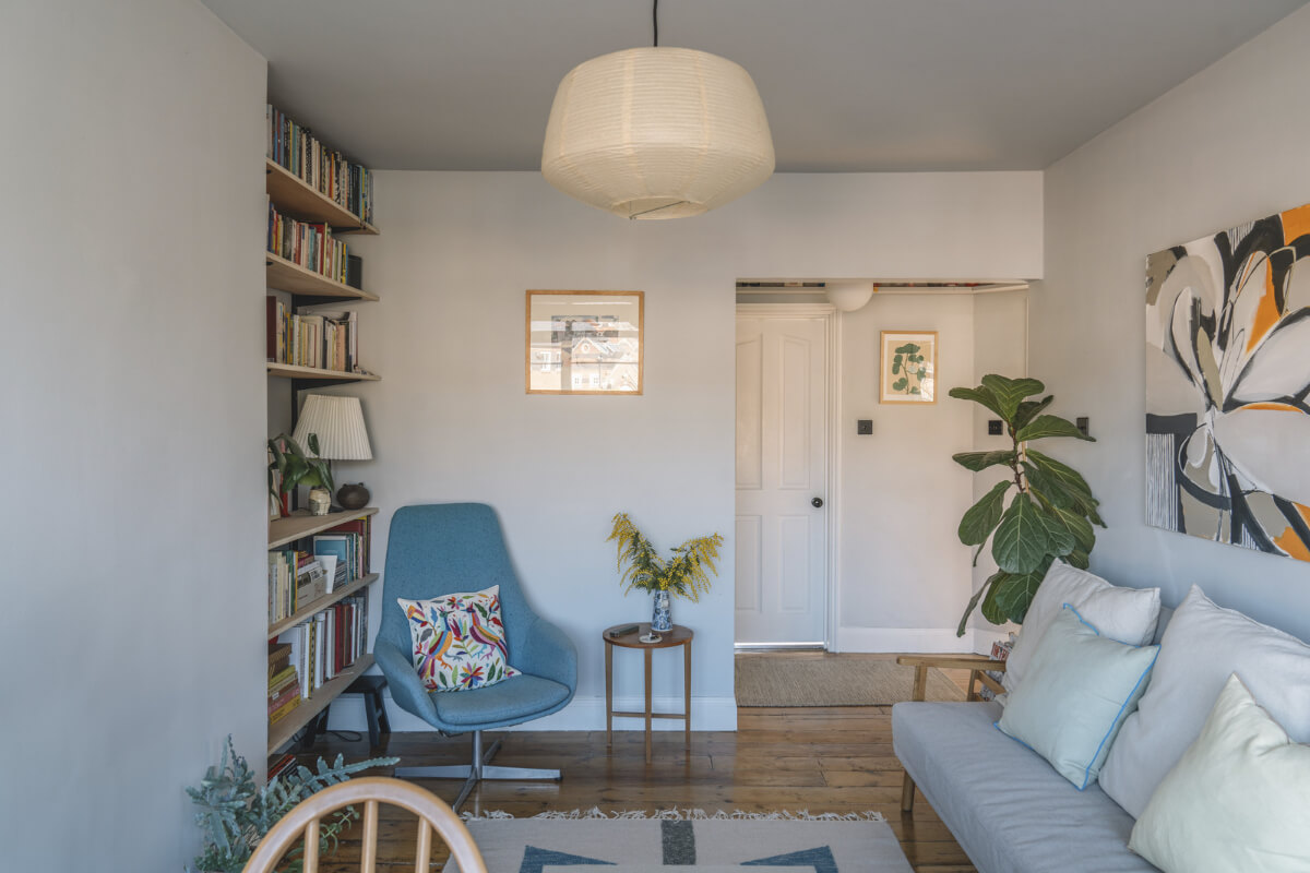 A London Apartment with a Pink and Green Kitchen 1 living room wooden floor bookshelves