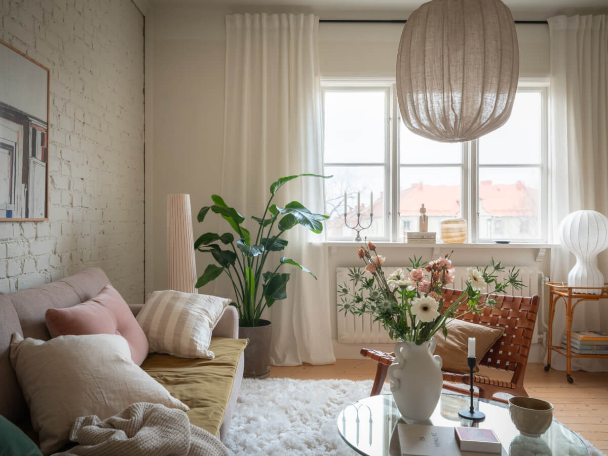 A Renovated Duplex Apartment with Exposed Brick Walls 3 living room wooden floor white painted brick wall