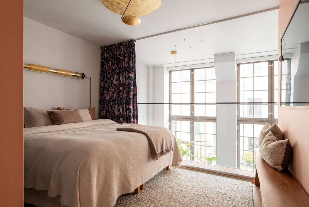 A Loft with High Ceilings and Large Windows in an Exclusive Stockholm Building 13 loft bedroom floral curtain