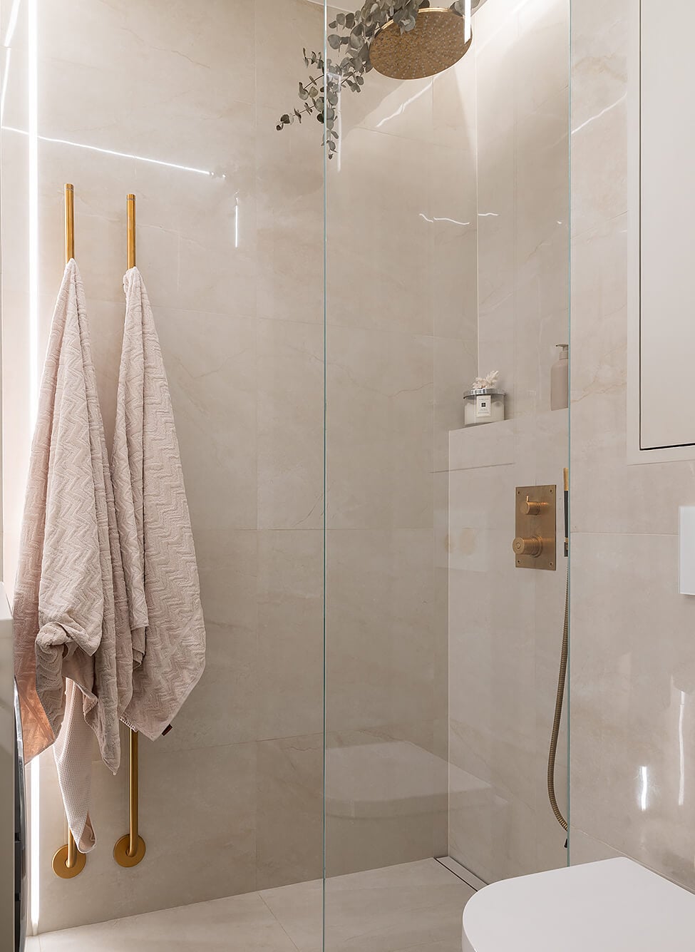 A Tiny and Luxurious Apartment in Stockholm 11 luxurious bathroom walk-in shower brass fittings