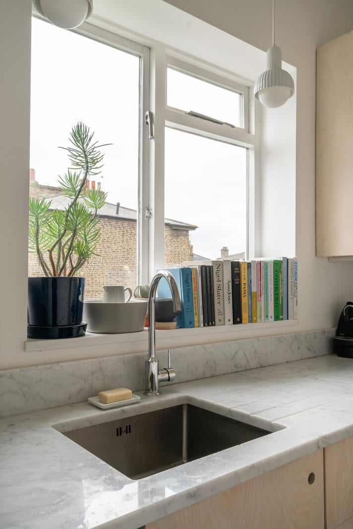 A Light One-Bedroom Apartment in a Victorian Terrace House 10 marble countertop sink under window