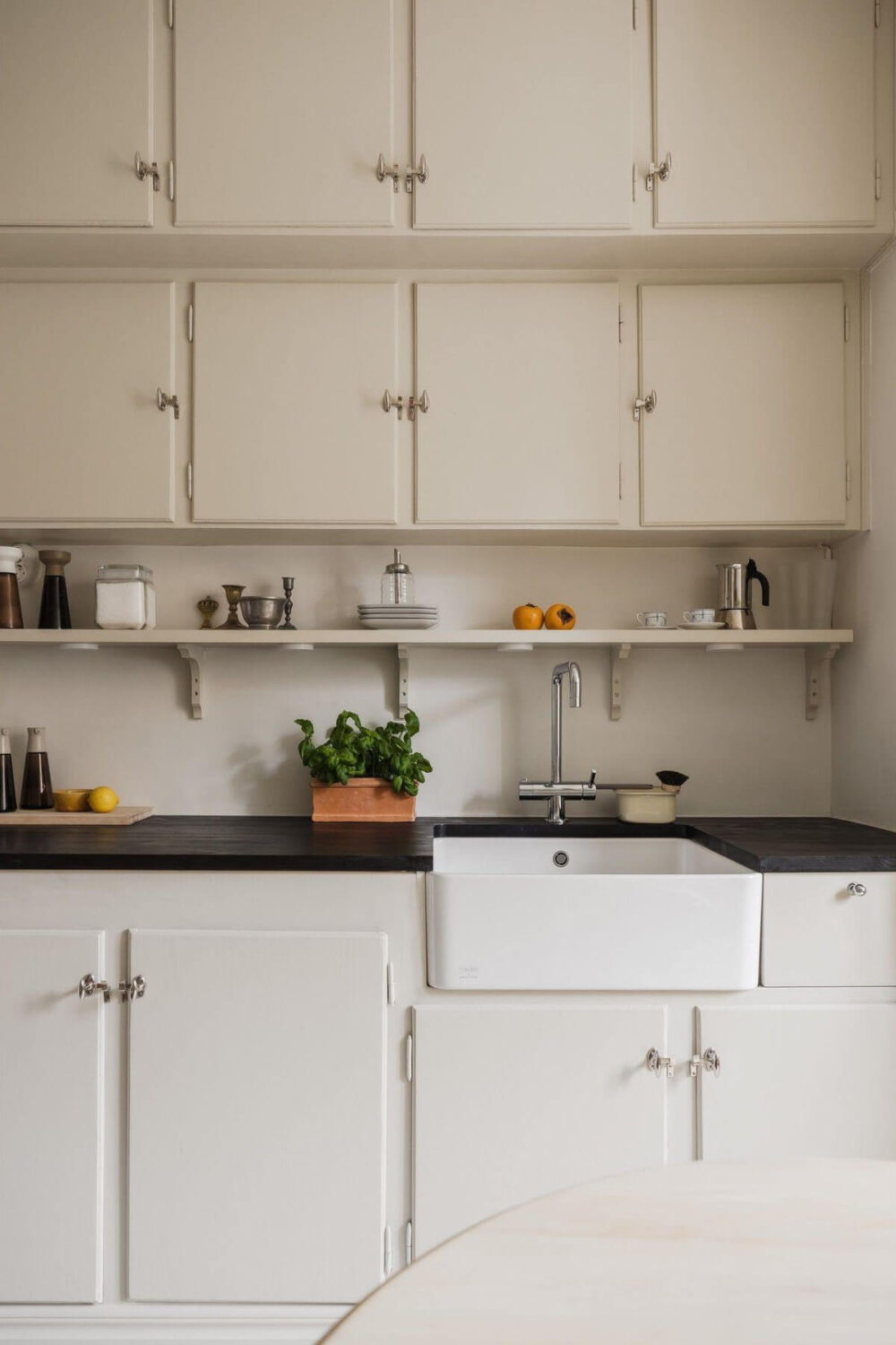 Natural Tones and Original Elements in a 1930s Apartment 8 midcentury kitchen double upper cabinets butler sink
