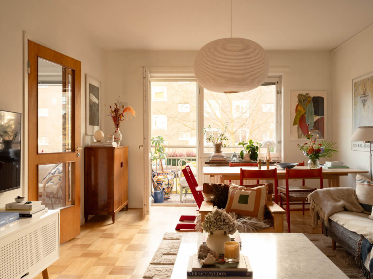 A Charming Midcentury Apartment with a Reading Room 3 midcentury living room parquet floor balcony