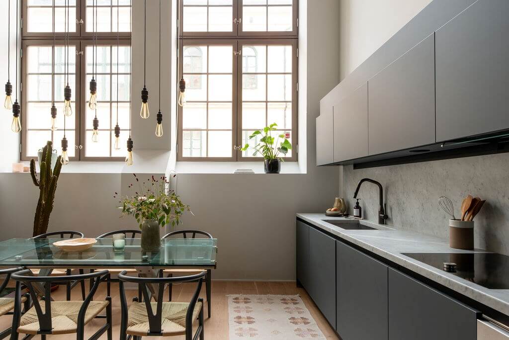 A Loft with High Ceilings and Large Windows in an Exclusive Stockholm Building 6 modern dark gray kitchen high windows