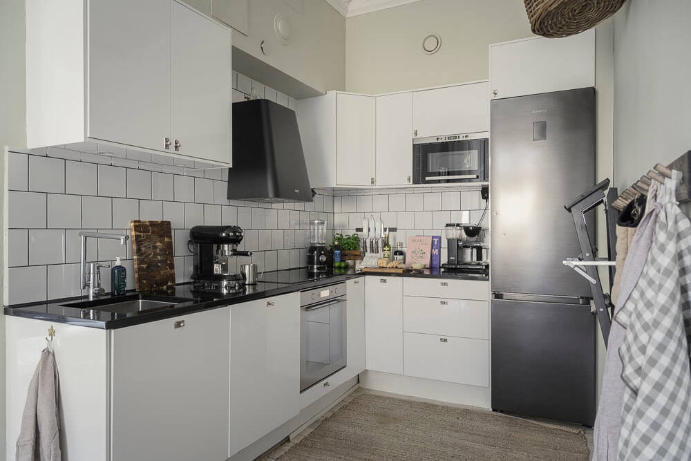 Limewash Wall and Period Features in a Swedish Apartment 9 modern white kitchen