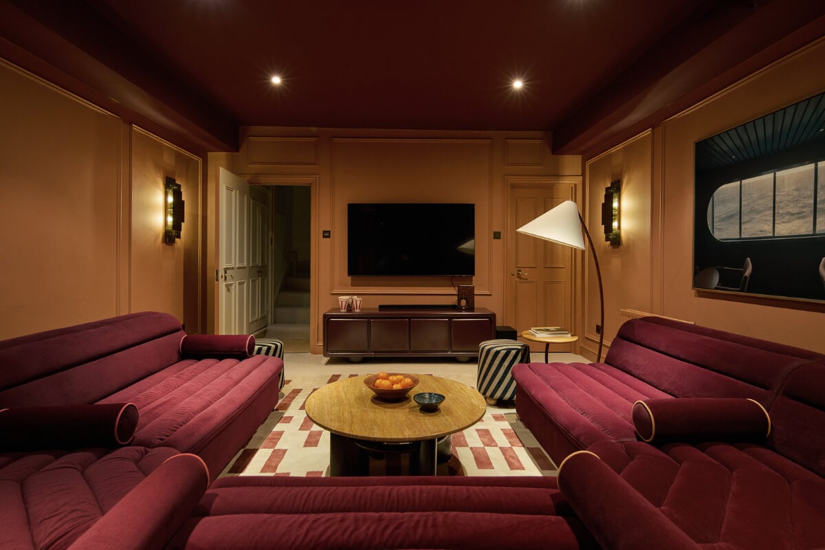 A Stunning Victorian House with Period Features and Surprising Spaces 15 moody cinema room burgundy velvet sofa