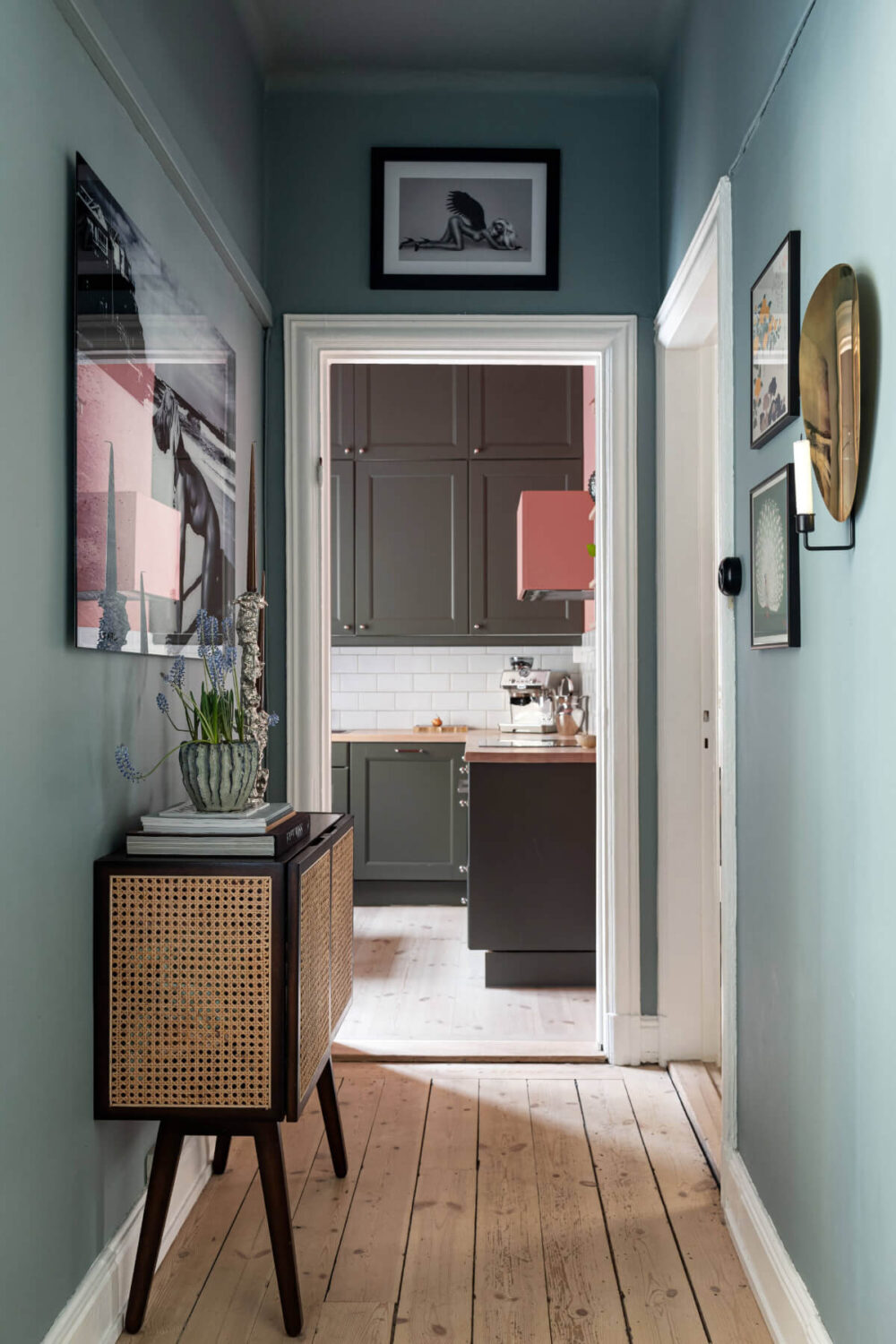 An Elegant Stockholm Apartment with a Pink and Black Kitchen 9 moody hall wooden floor
