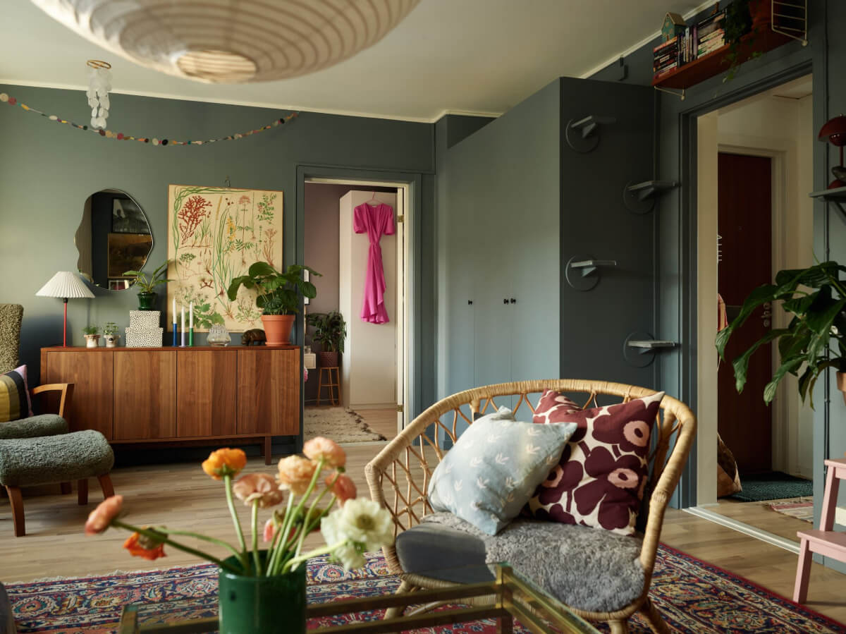 A Colorful Midcentury Apartment Filled with Art and Plants 8 moody living room with wardrobes