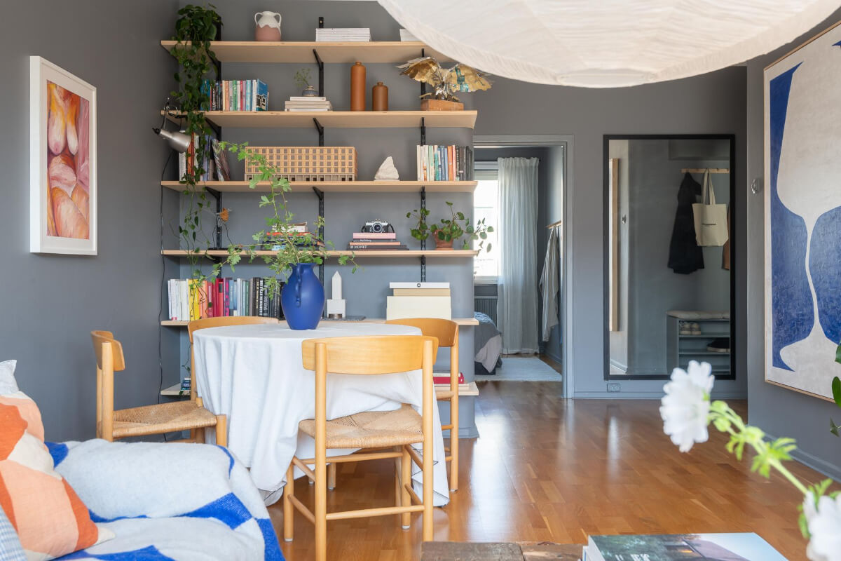 Light Rooms and a Moody Color Palette in a 1930s Apartment 11 open living room with round dining table