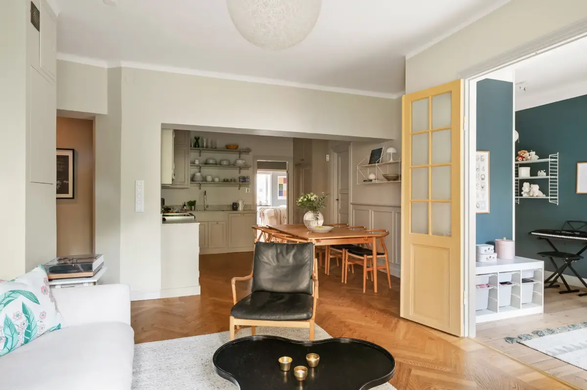 A Charming Ground Floor Family Apartment in Stockholm 5 open plan beige living space herringbone parquet floor