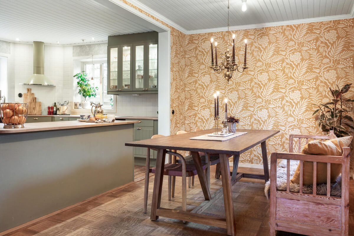 A Charming Home with Lake Views South of Stockholm 6 open plan kitchen dining room gold wallpaper