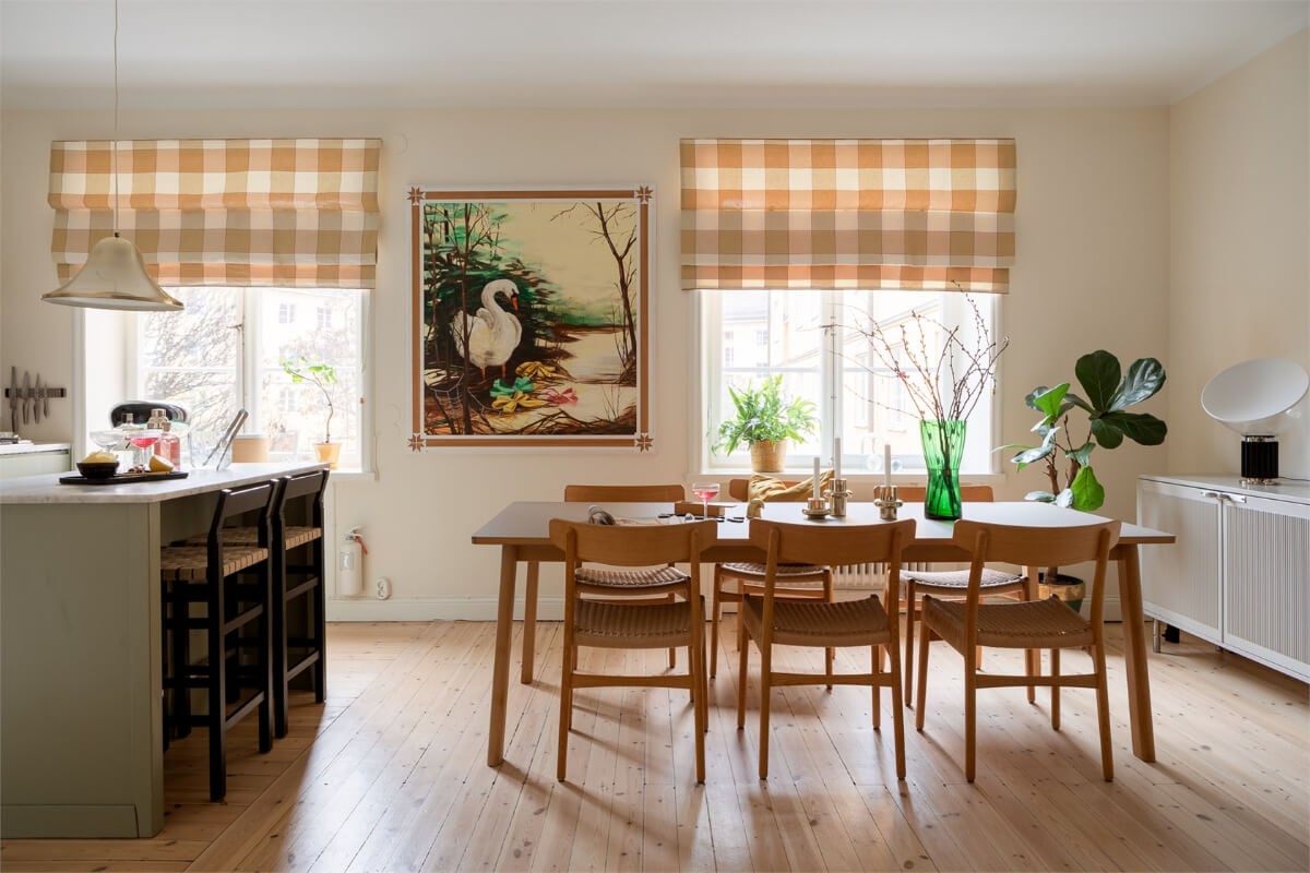 A Light-Filled Two Bedroom Apartment in Stockholm 3 open plan kitchen dining room yellow checkerboard blinds