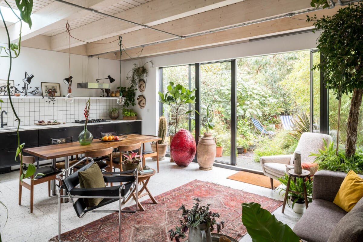A Unique House in London with Plant-Filled Interiors and a Lush Garden 1 open-plan living room kitchen with plants and garden access