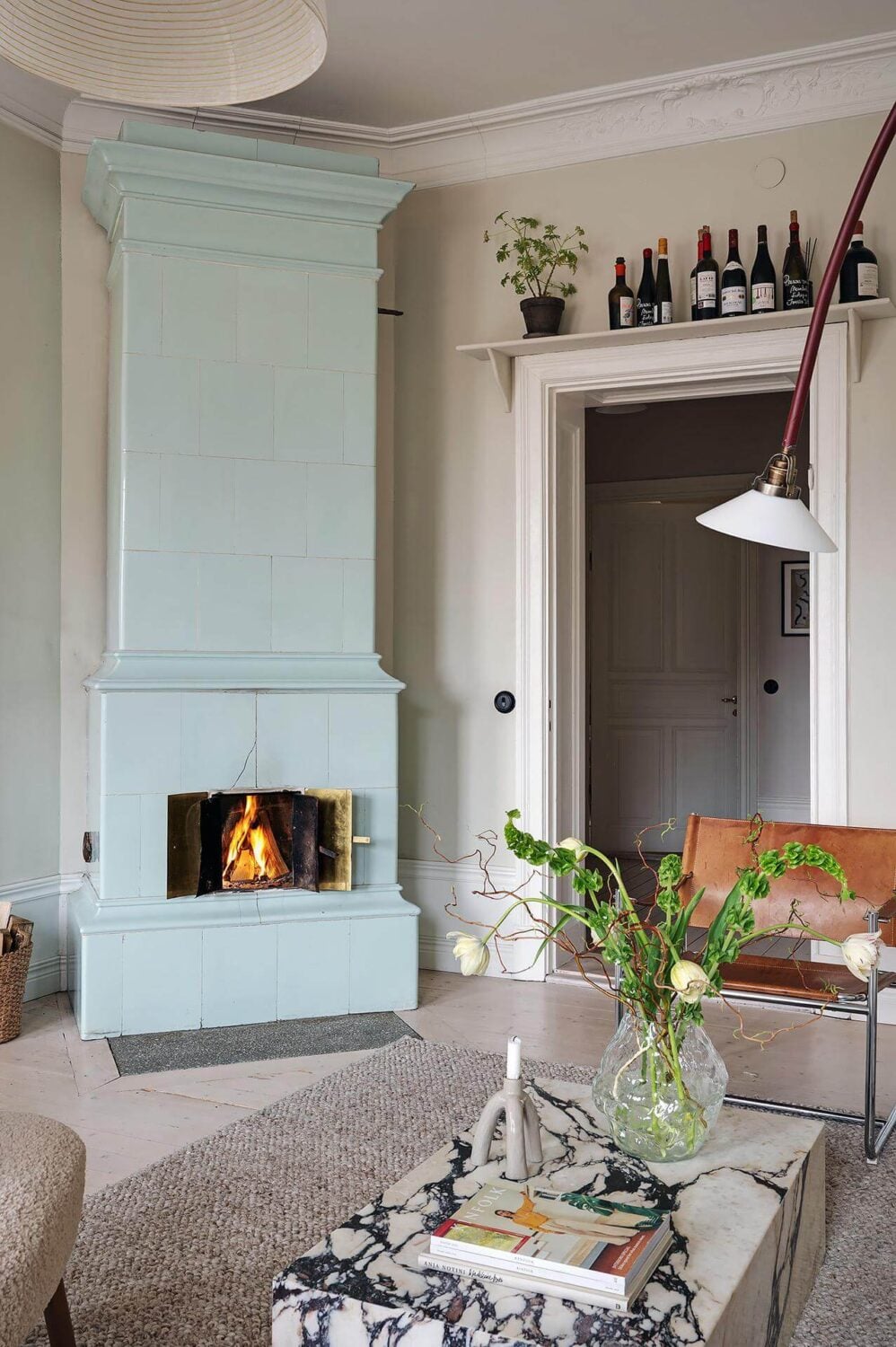 Period Features and Modern Materials in a Swedish Apartment 16 pale blue fireplace shelf above window