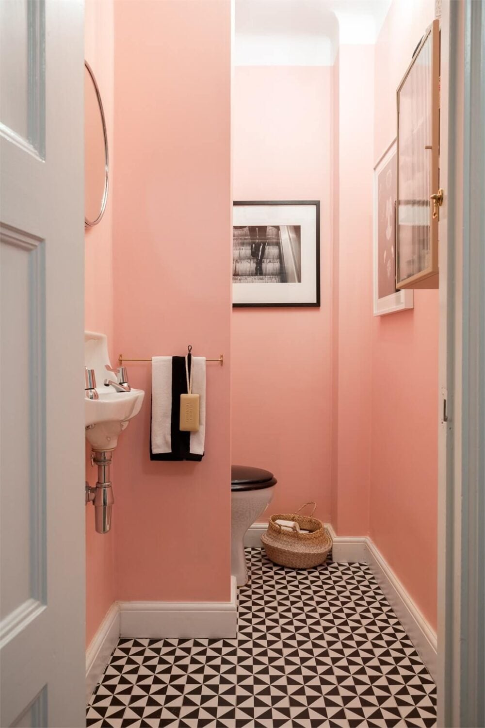 A Light-Filled Two Bedroom Apartment in Stockholm 20 pink powder room black and white tile floor