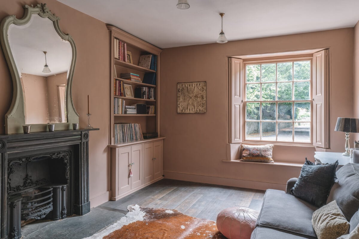 A Beautiful Renovated Country House in England 5 pink sitting room black fireplace window seat