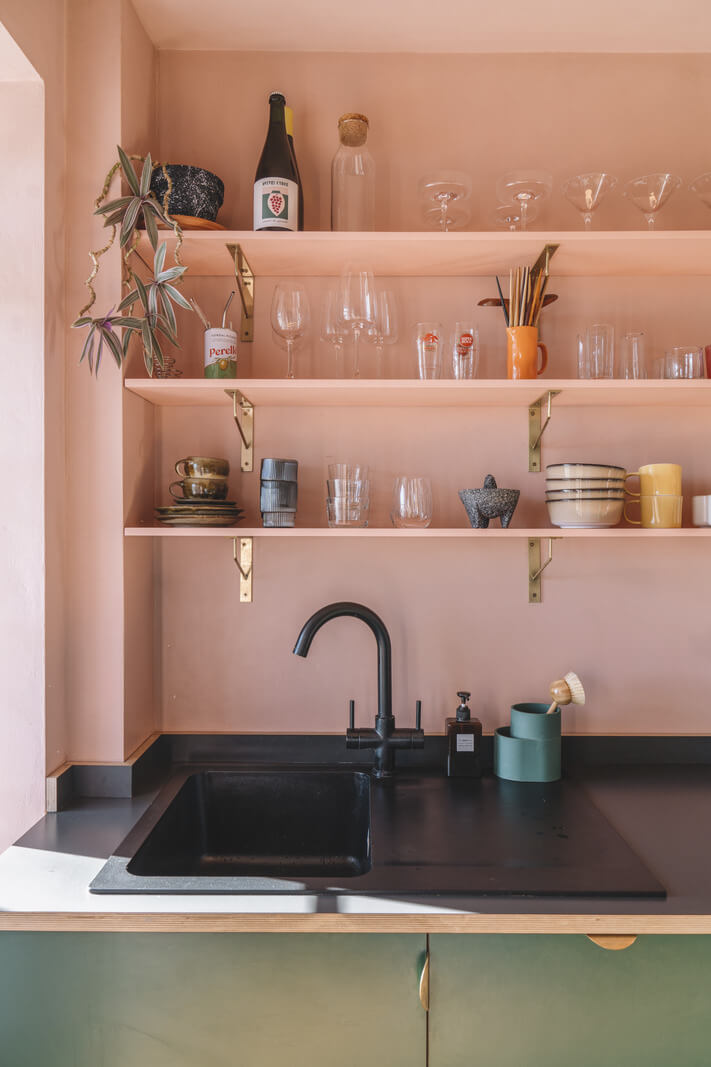 A London Apartment with a Pink and Green Kitchen 8 pink walls and shelves green cabinets black fittings