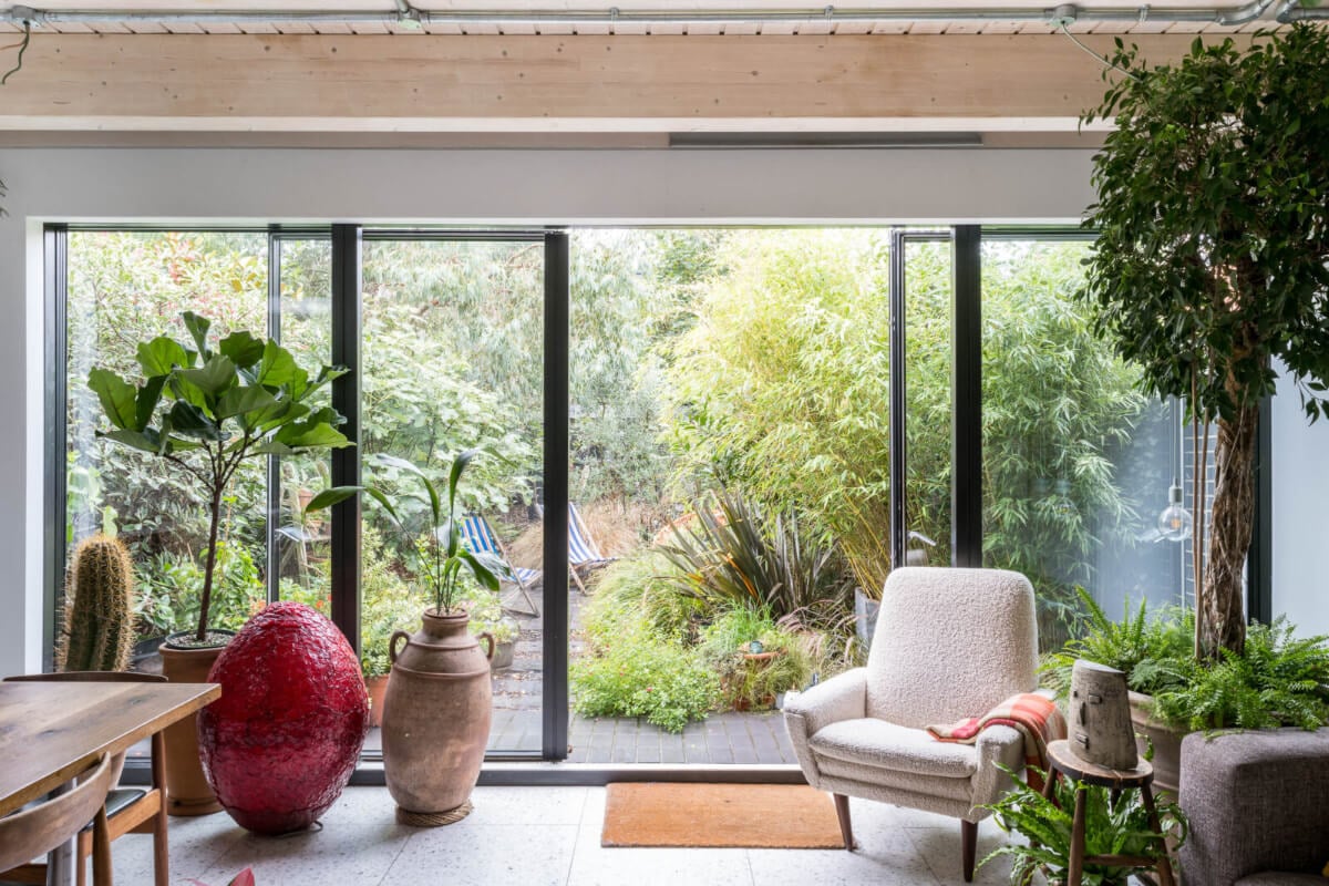 A Unique House in London with Plant-Filled Interiors and a Lush Garden 2 plant-filled kitchen dining room with lush garden access