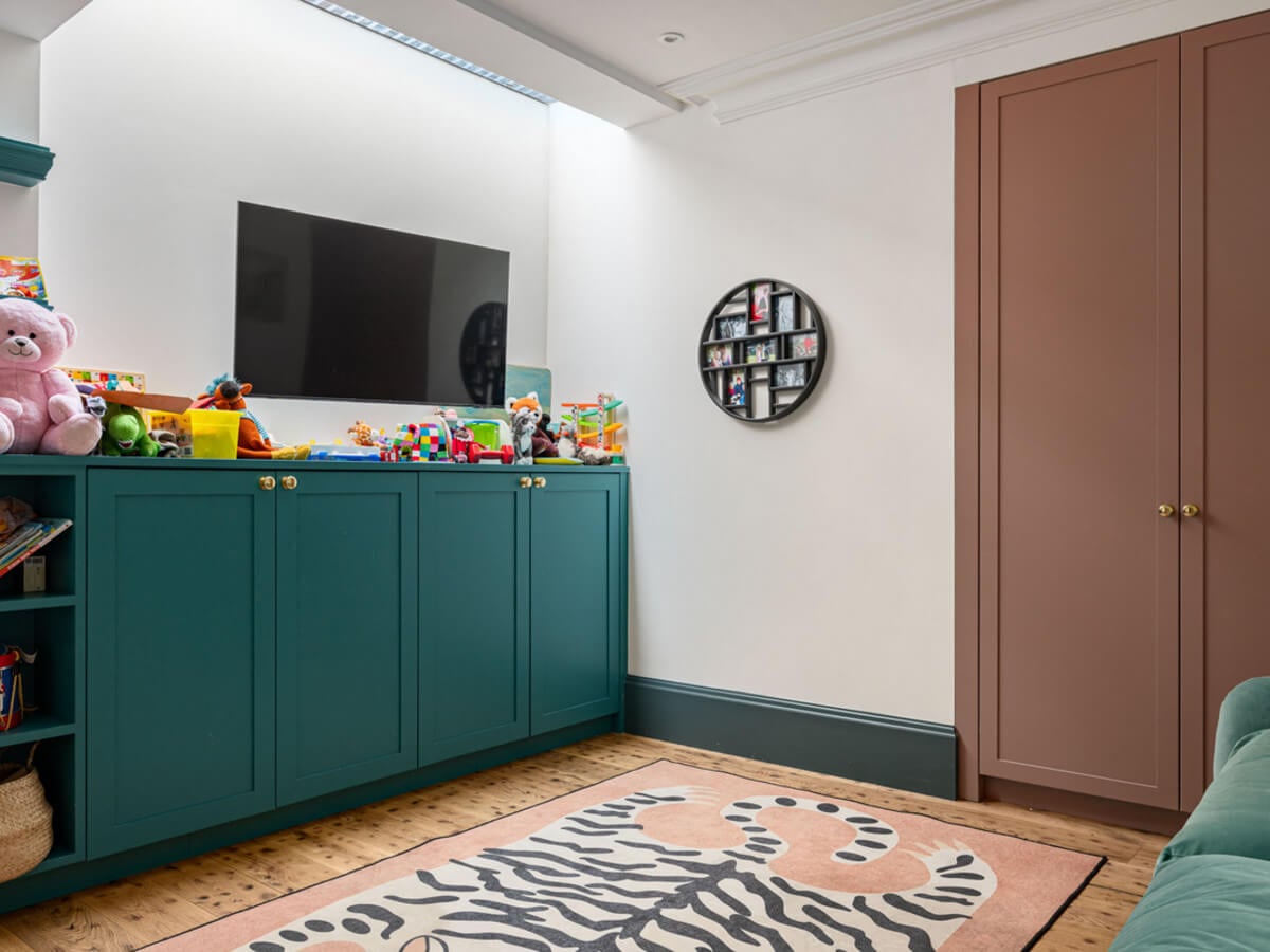 An Extended Family Home in London with Pink Crittall Doors 8 play room with colorful storage cabinets