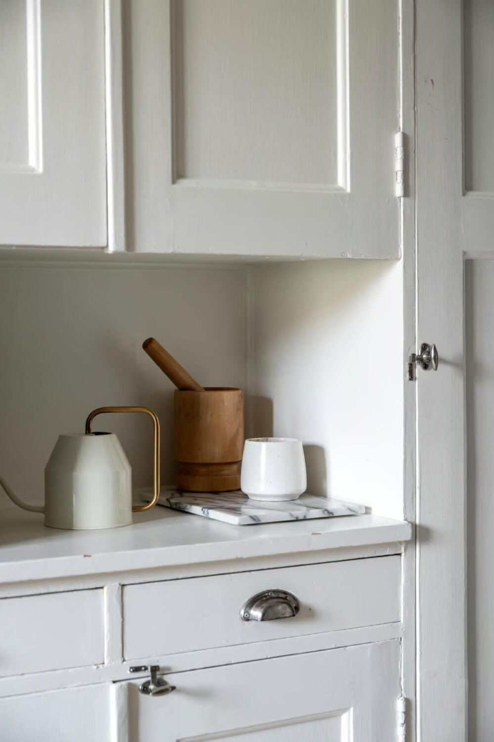 A Swedish Attic Apartment with Exposed Brick and Yellow Color Accents 11 preserved original kitchen cupboard