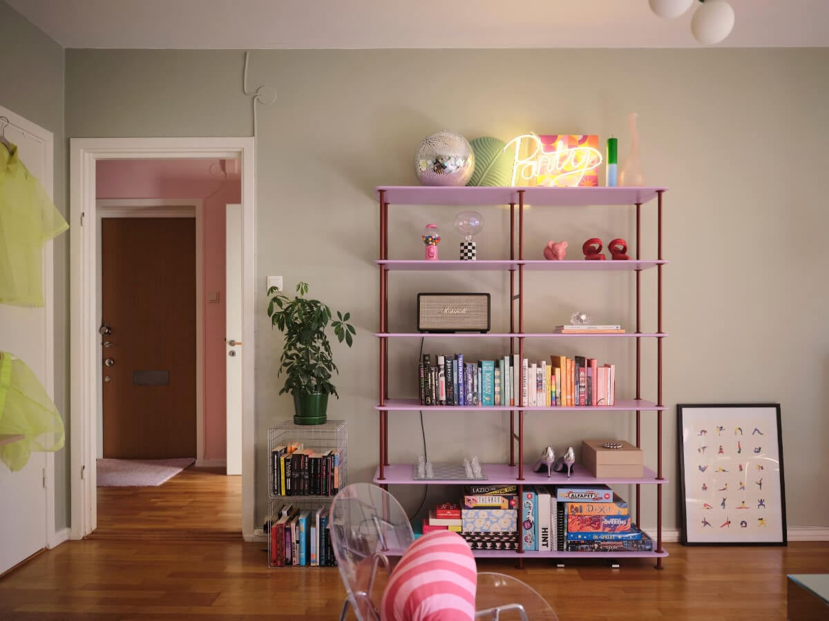 A Midcentury Swedish Apartment with Bright Color Accents 8 purple bookshelves