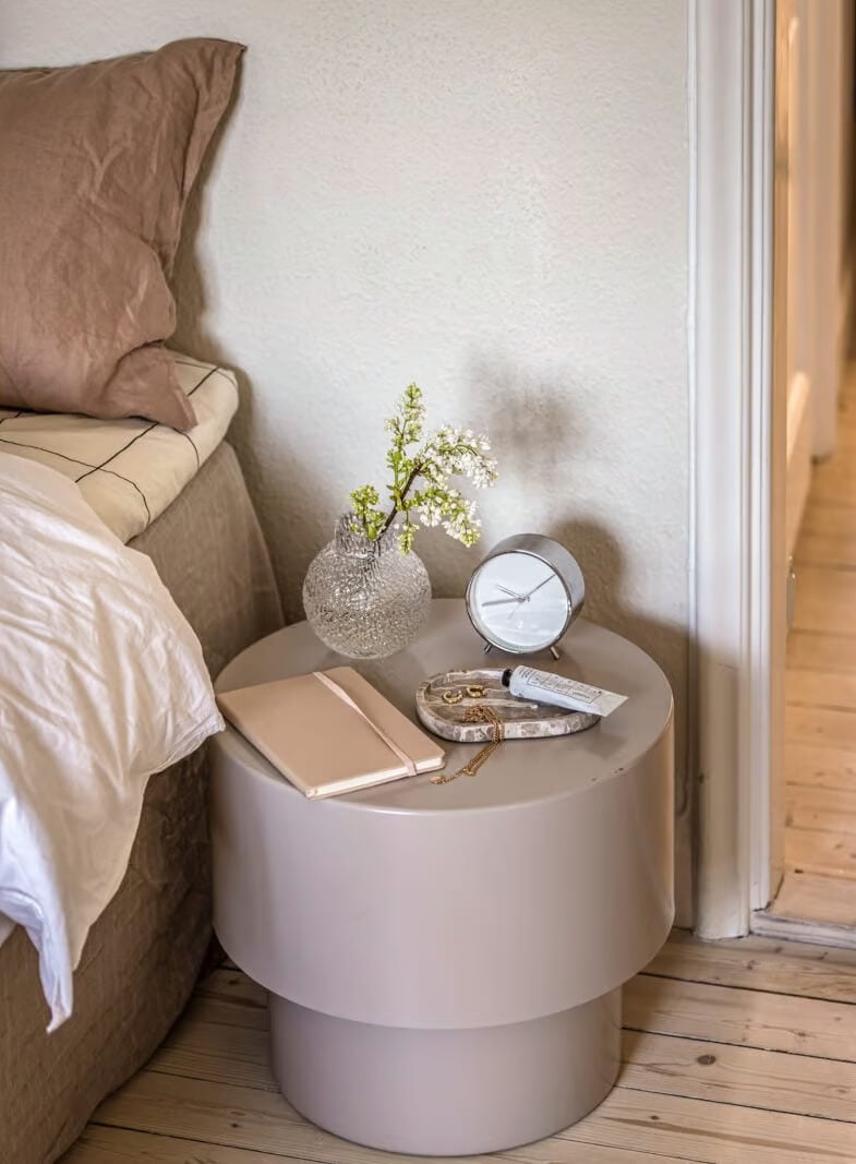 A Beige Studio Apartment with a Bright Kitchen 5 round beige nightstand