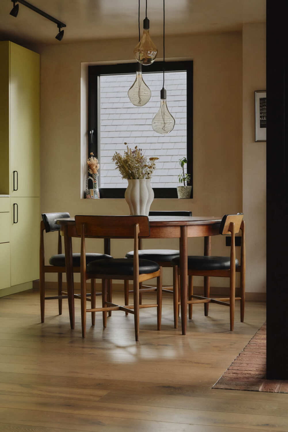 An Elegant Apartment with Plaster Walls and a Winter Garden 6 round dining table