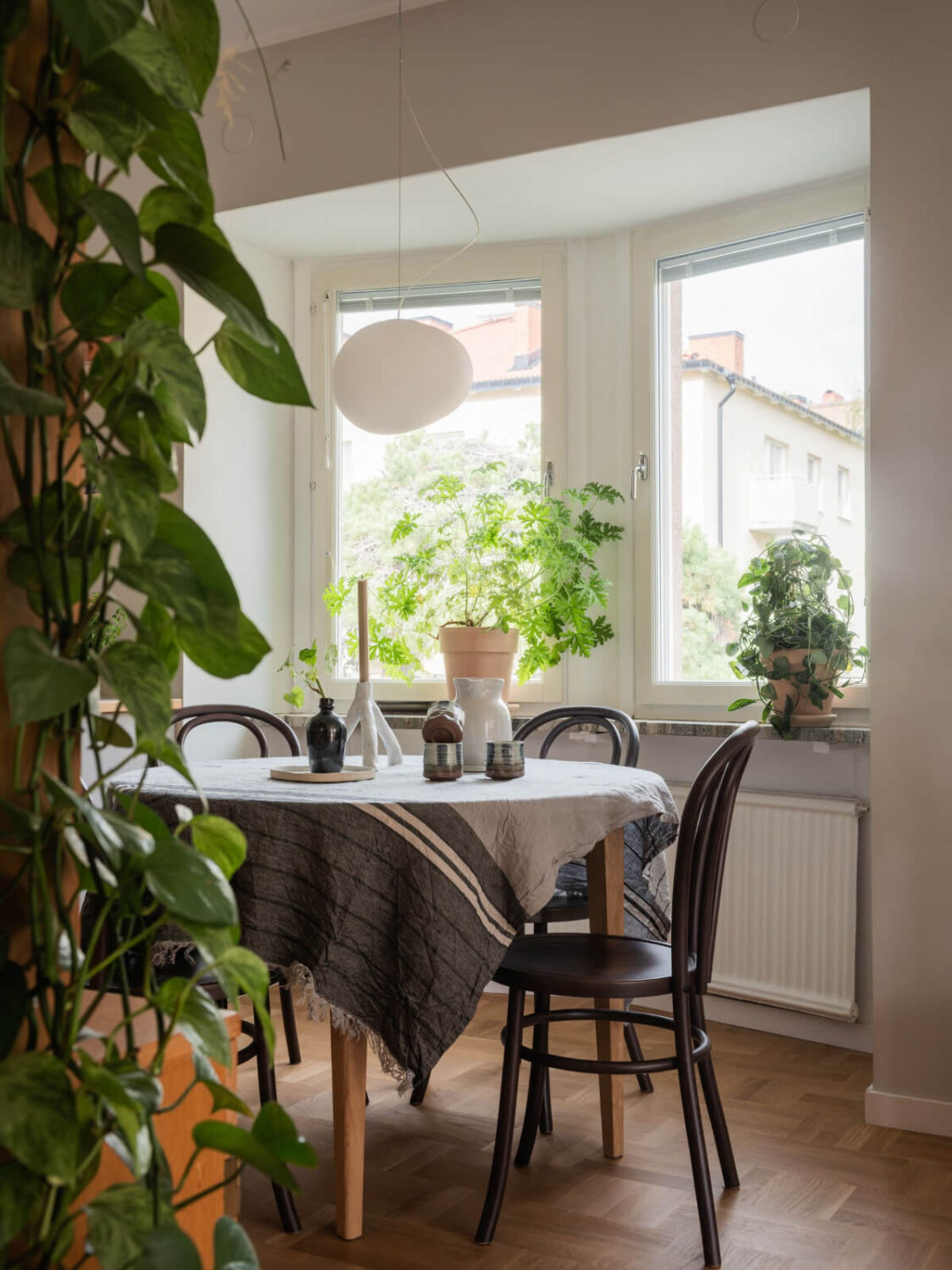 A Swedish 1940s Apartment with Lovely Balcony Views 9 round dining table bay window