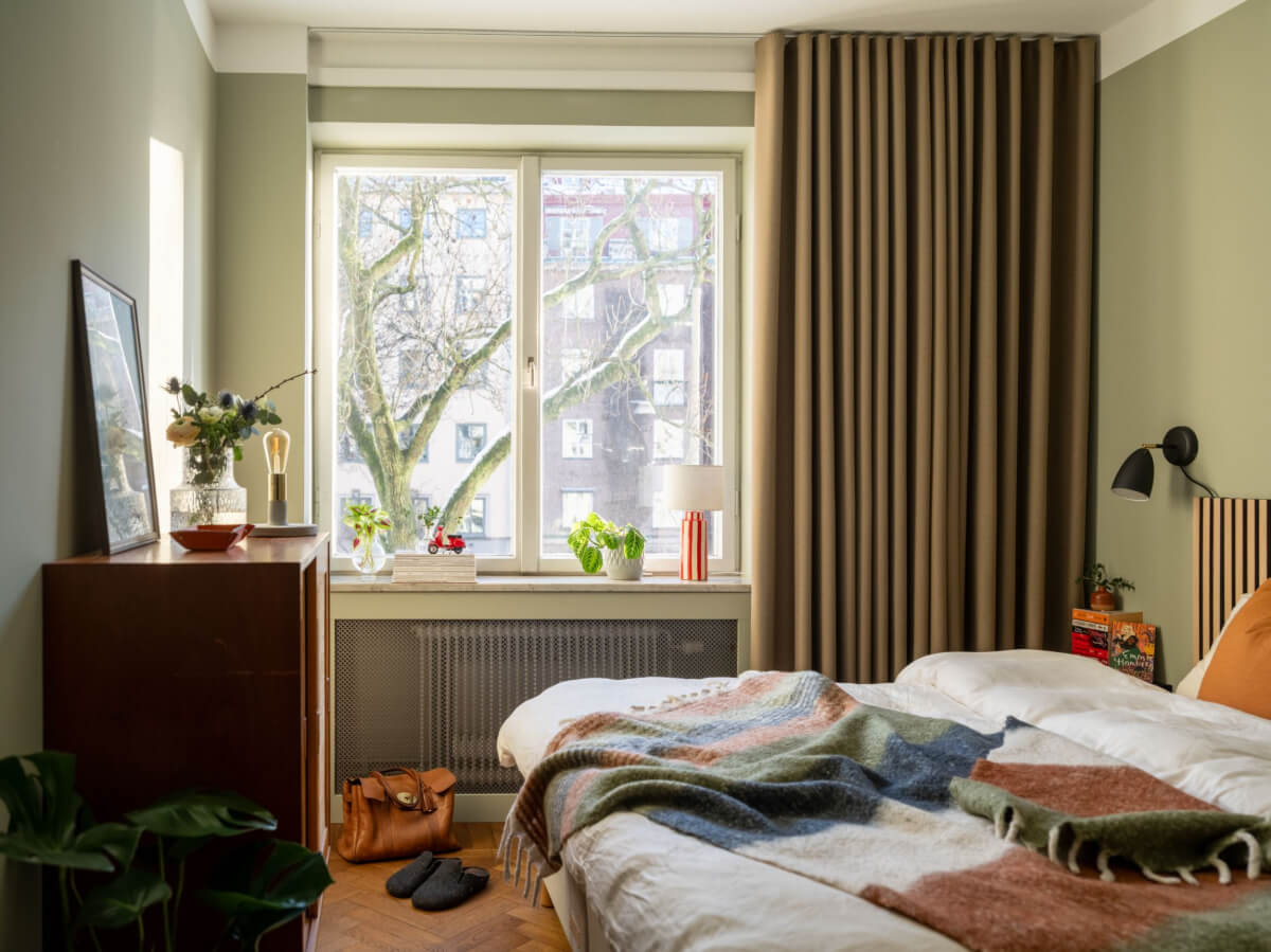 A Light, Renovated Two-Bedroom Apartment in Stockholm 13 sage green bedroom parquet floor