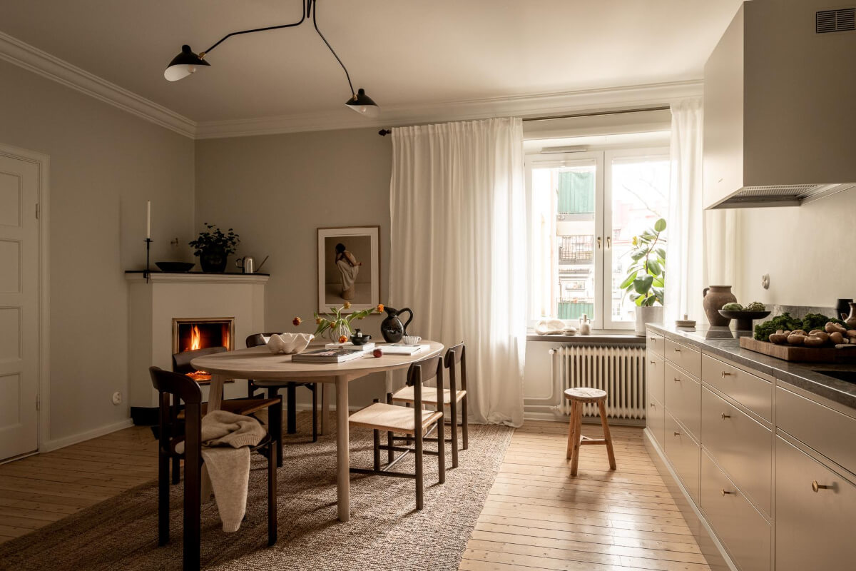 A Beautiful Calm 1920s Apartment in Gothenburg 11 scandi kitchen with large dining table on rug