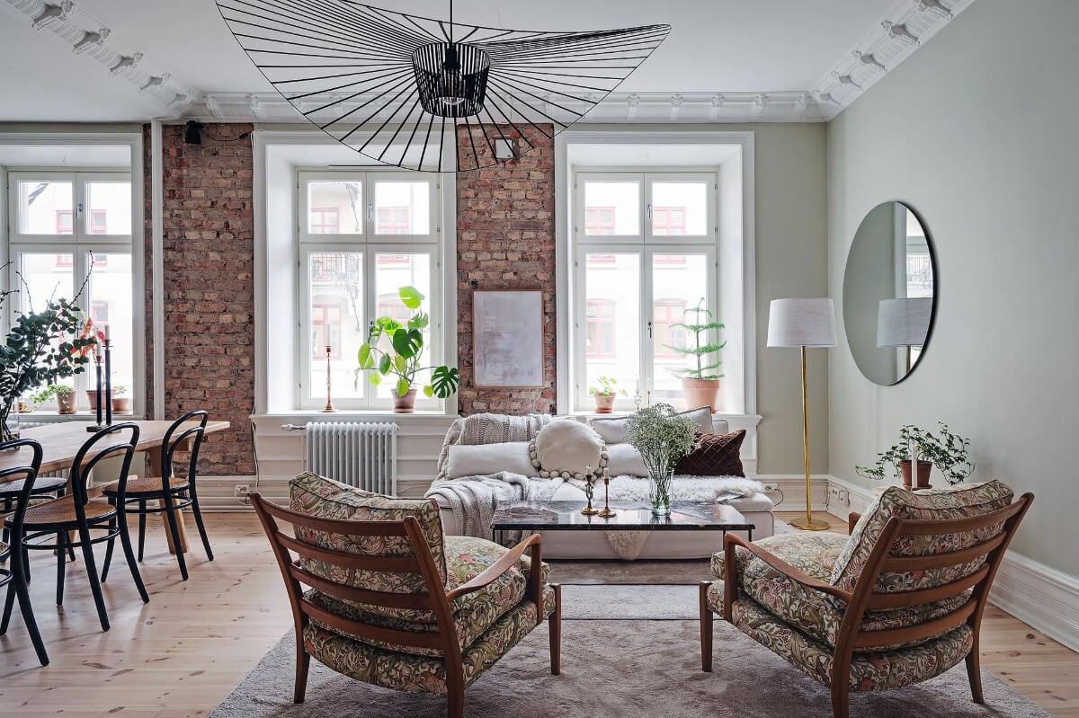 A Swedish Apartment with an Open Living Space and Period Features 2 scandi sitting room round mirror brick wall