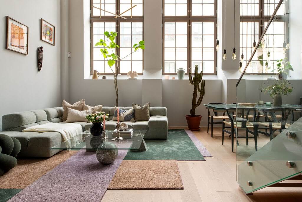 A Loft with High Ceilings and Large Windows in an Exclusive Stockholm Building 1 scandinavian loft large windows colorful rug